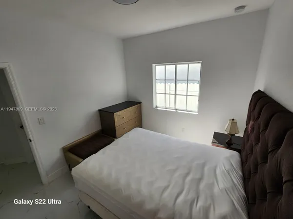 a bedroom with a bed and window