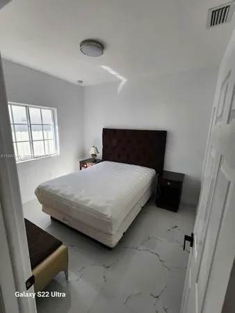a bedroom with a bed and a mirror