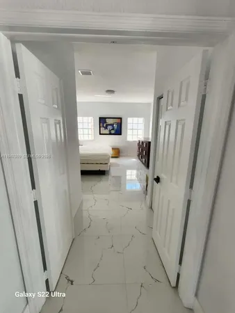 a bedroom with furniture and a flat screen tv