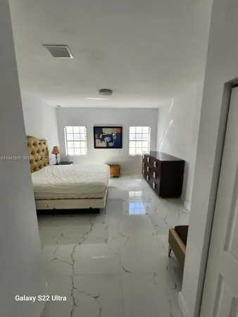 a bedroom with a bed and lamp