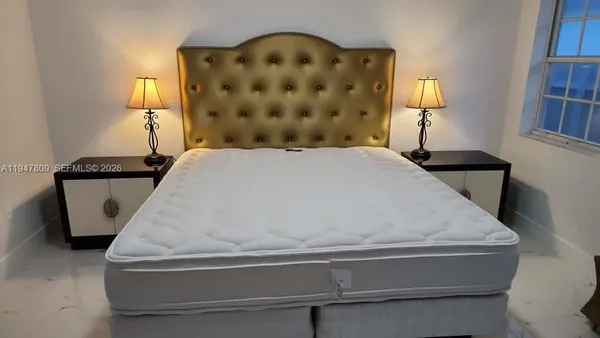 a bedroom with a bed couch and window
