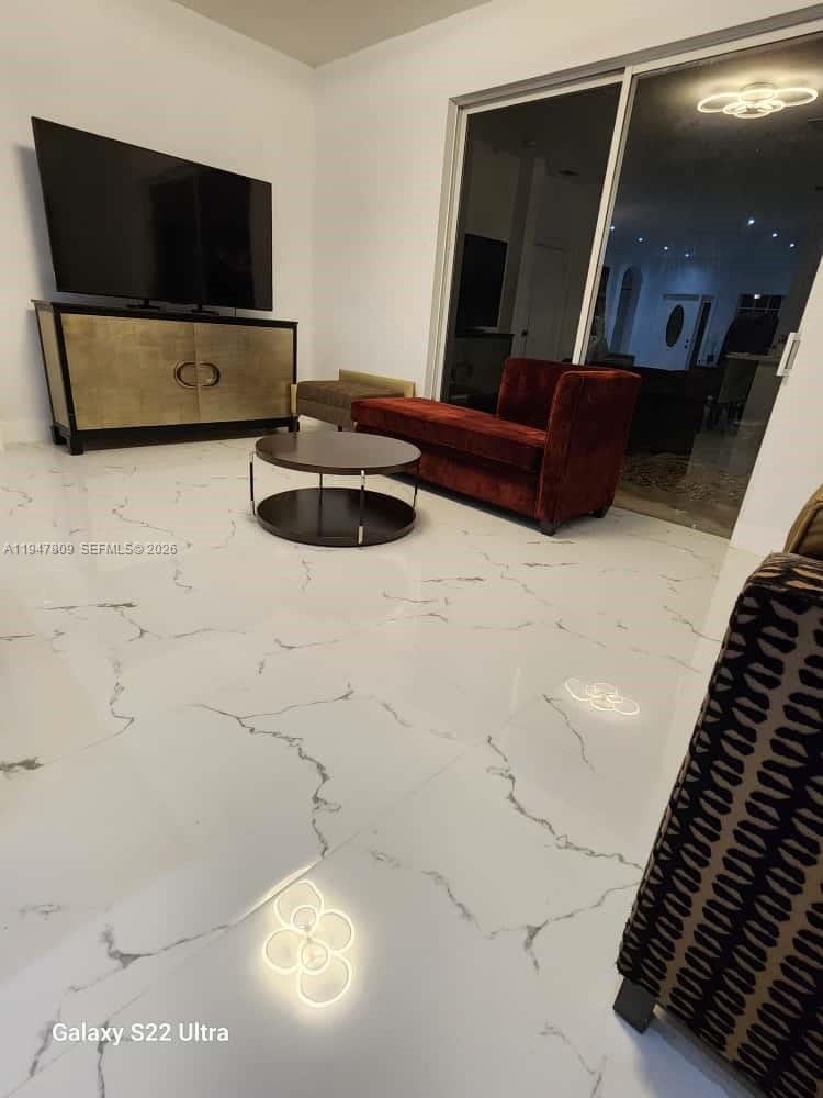 18252 Southwest 146th Avenue Miami, FL 33177 - Photo 32 of 46 a living room with furniture and a flat screen tv