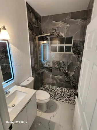 a bathroom with a toilet and a shower