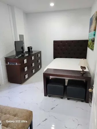 a bedroom with a bed and a cabinets