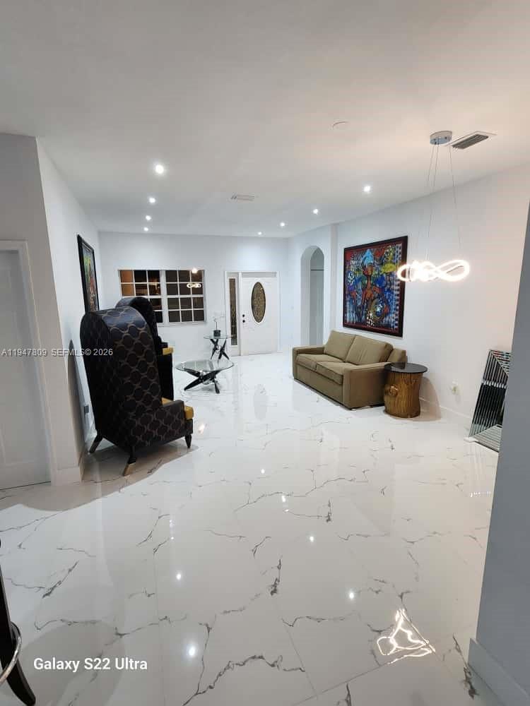 18252 Southwest 146th Avenue Miami, FL 33177 - Photo 4 of 46 a living room with furniture and a flat screen tv