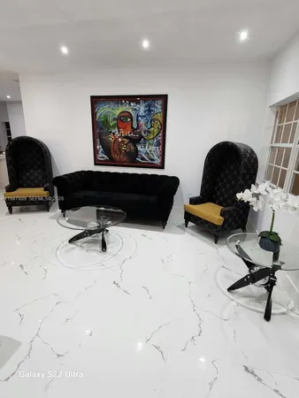 a living room with furniture and a gym equipment