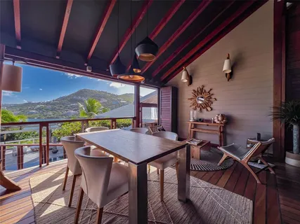 a dining room with furniture and window