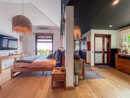 a bedroom with furniture and a wooden floor