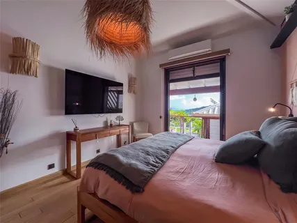 a bedroom with a bed and a flat screen tv