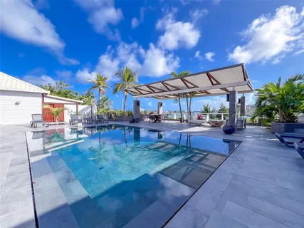 a view of a swimming pool with outdoor seating
