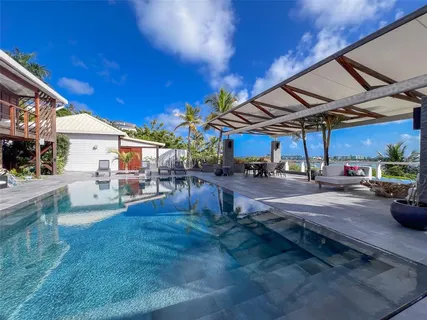 a view of a patio with table and chairs and potted plants