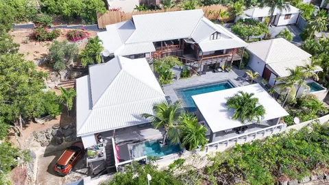 an aerial view of a house with garden space and street view