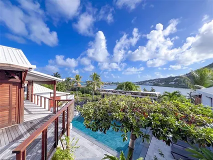 a view of a house with a yard from a balcony