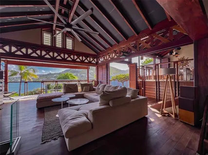 a living room with furniture and a floor to ceiling window