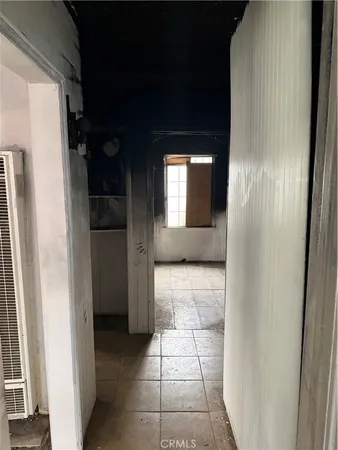 a view of hallway with a large window and a mirror