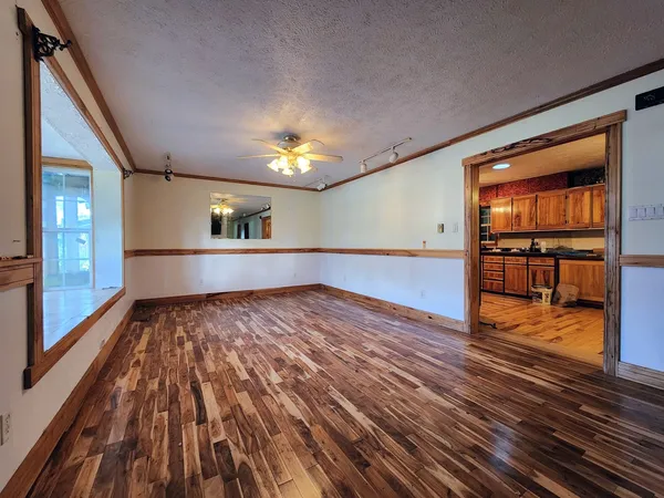 a view of wooden floor and a window in an empty room