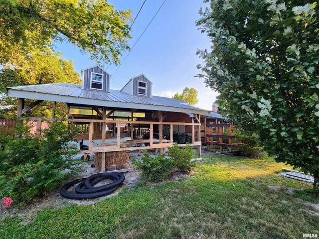 a front view of a house with a yard table and chairs