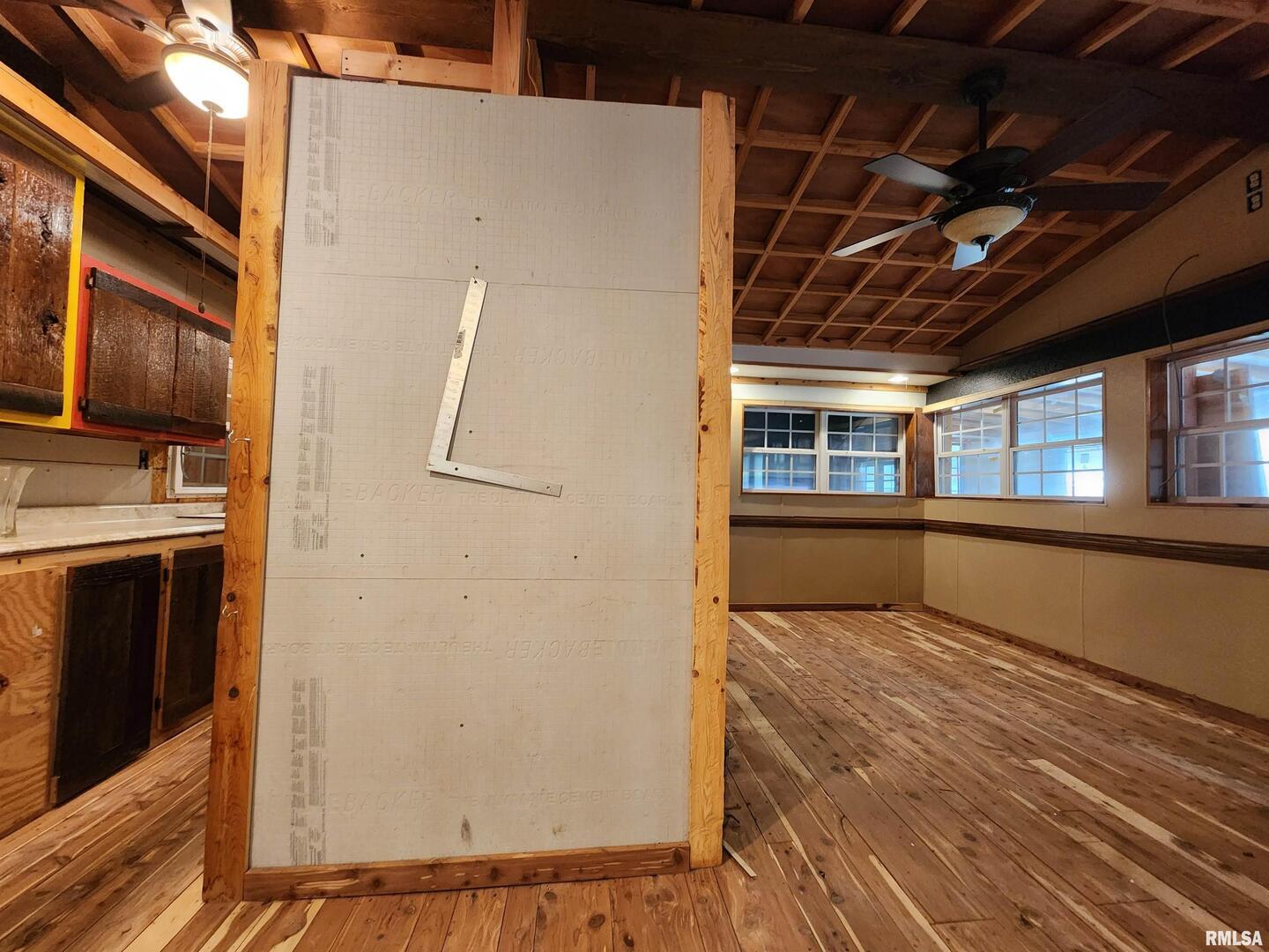 5628 Coal Street Sesser, IL 62884 - Photo 25 of 62 a view of an empty room with wooden floor and a kitchen