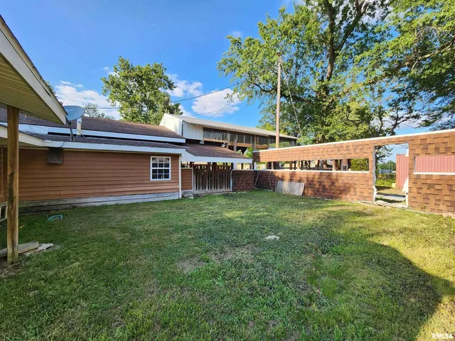 a view of a porch with furniture and backyard