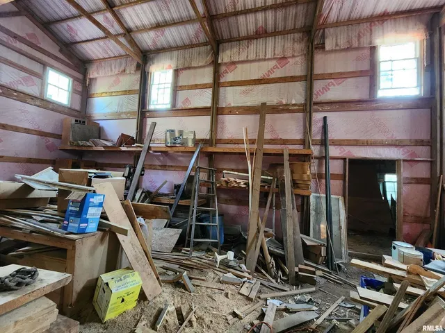 a view of house with backyard and sitting area