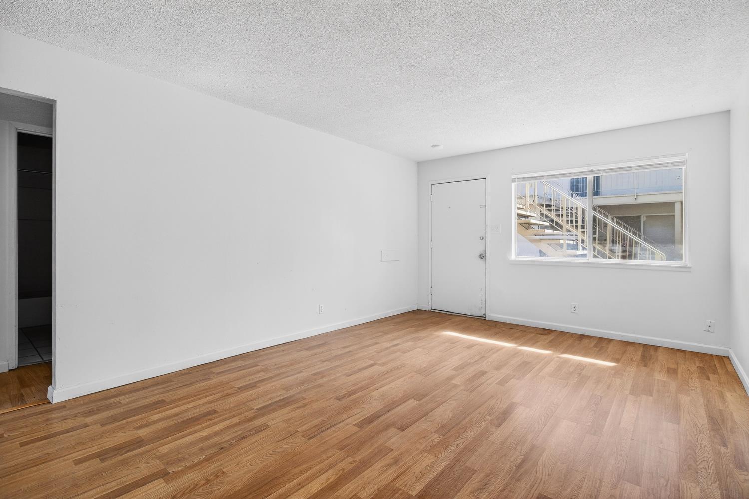 1962 Edwards Avenue Merced, CA 95340 - Photo 15 of 22 an empty room with wooden floor and windows