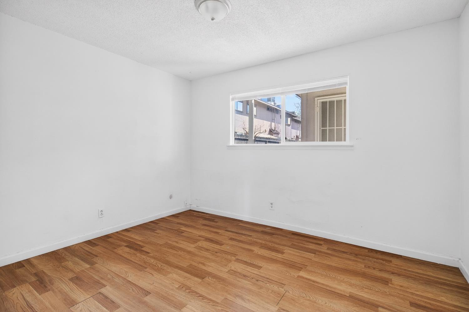 1962 Edwards Avenue Merced, CA 95340 - Photo 19 of 22 a view of empty room with wooden floor and fan