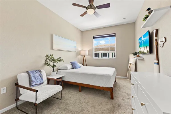 a bedroom with a bed and a painting on the wall