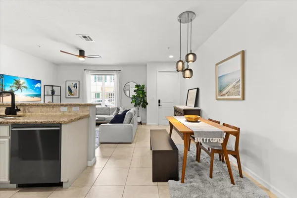 a kitchen with stainless steel appliances granite countertop a refrigerator sink and stove