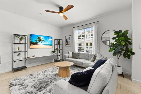 a living room with furniture a rug and a window
