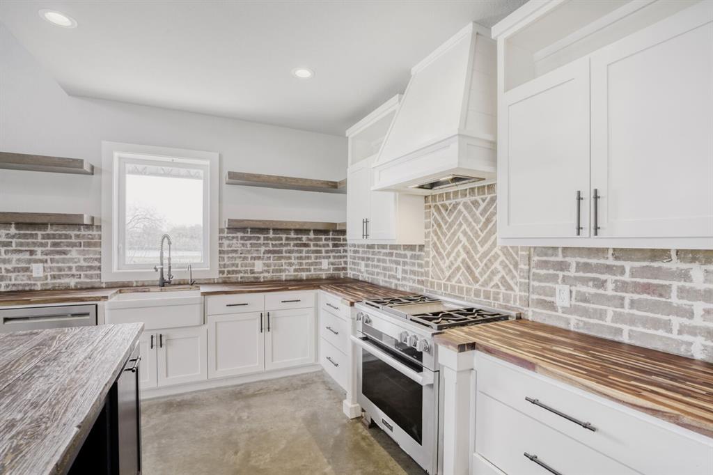 2515 County 141 Road Kaufman, TX 75142 - Photo 7 of 38 Well appointed farm house kitchen with custom cabinetry for storage, trash receptacles, and small kitchen appliances