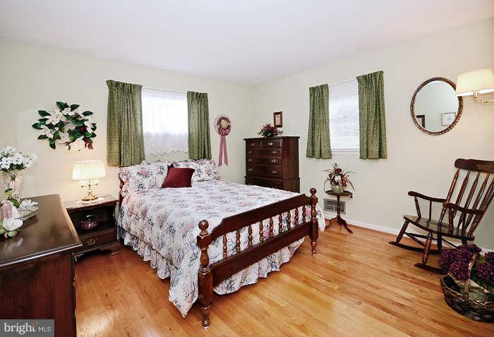 3211 Hunt Road Fallston, MD 21047 - Photo 13 of 25 a bedroom with a bed a dresser with mirror