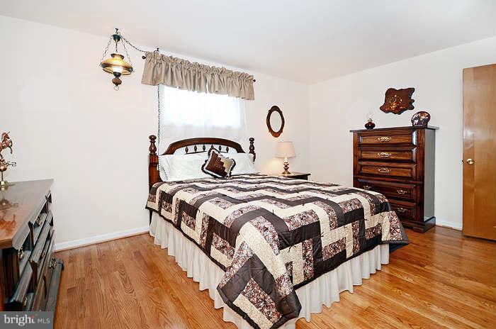 3211 Hunt Road Fallston, MD 21047 - Photo 15 of 25 a bedroom with a bed and wooden floor