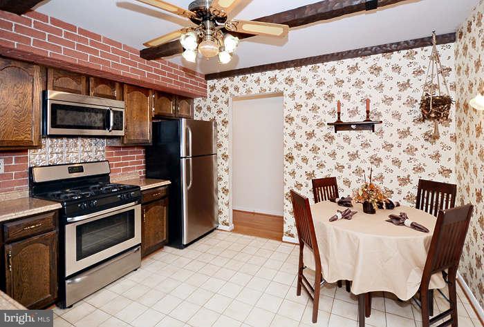 3211 Hunt Road Fallston, MD 21047 - Photo 7 of 25 a kitchen with stainless steel appliances granite countertop a dining table and chairs