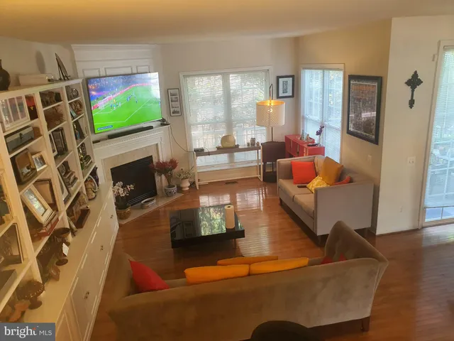 a living room with fireplace furniture and a flat screen tv