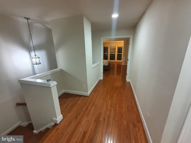 a view of a hallway and wooden floor