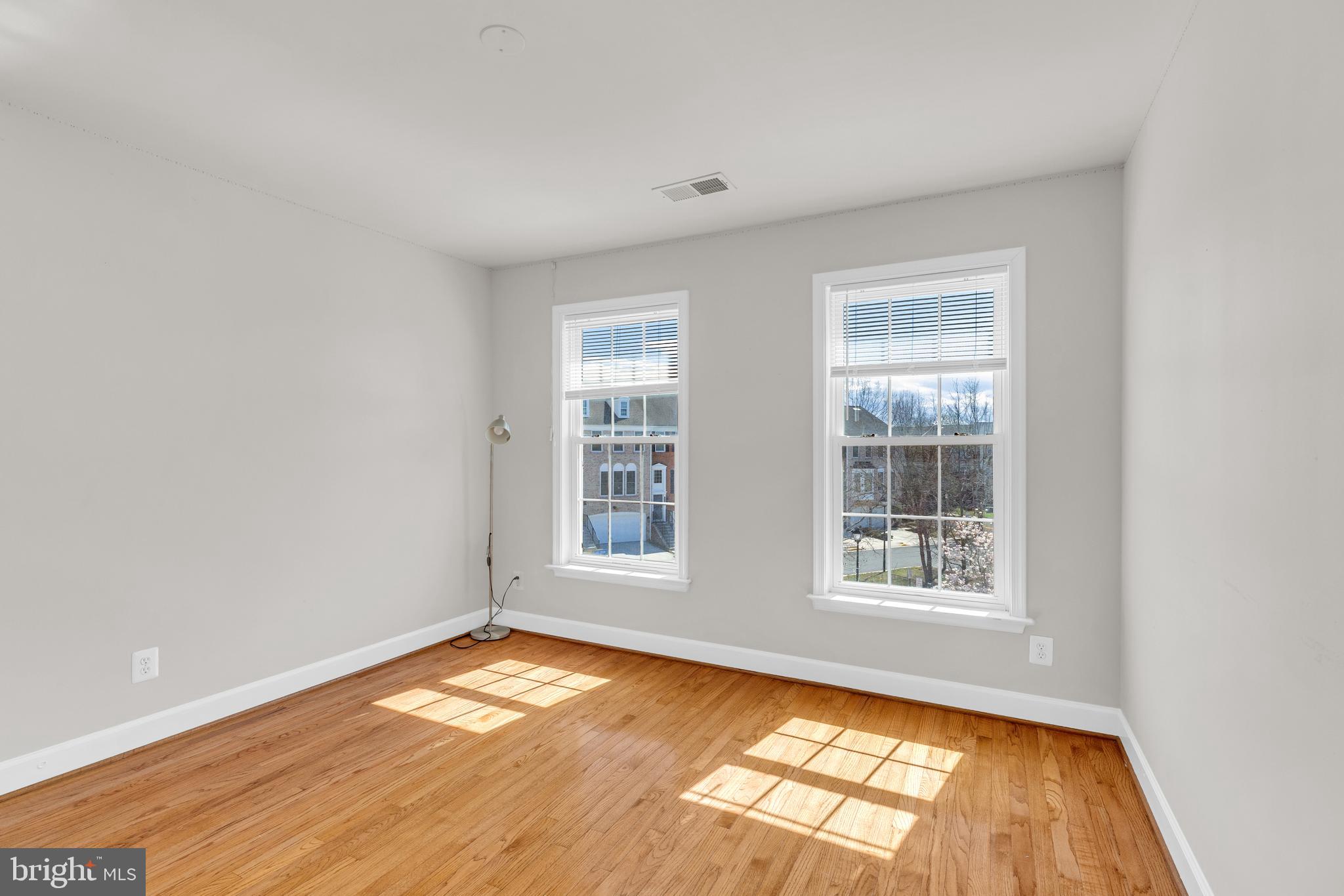 9249 Laurel Ridge Crossing Road Lorton, VA 22079 - Photo 14 of 38 an empty room with wooden floor and windows