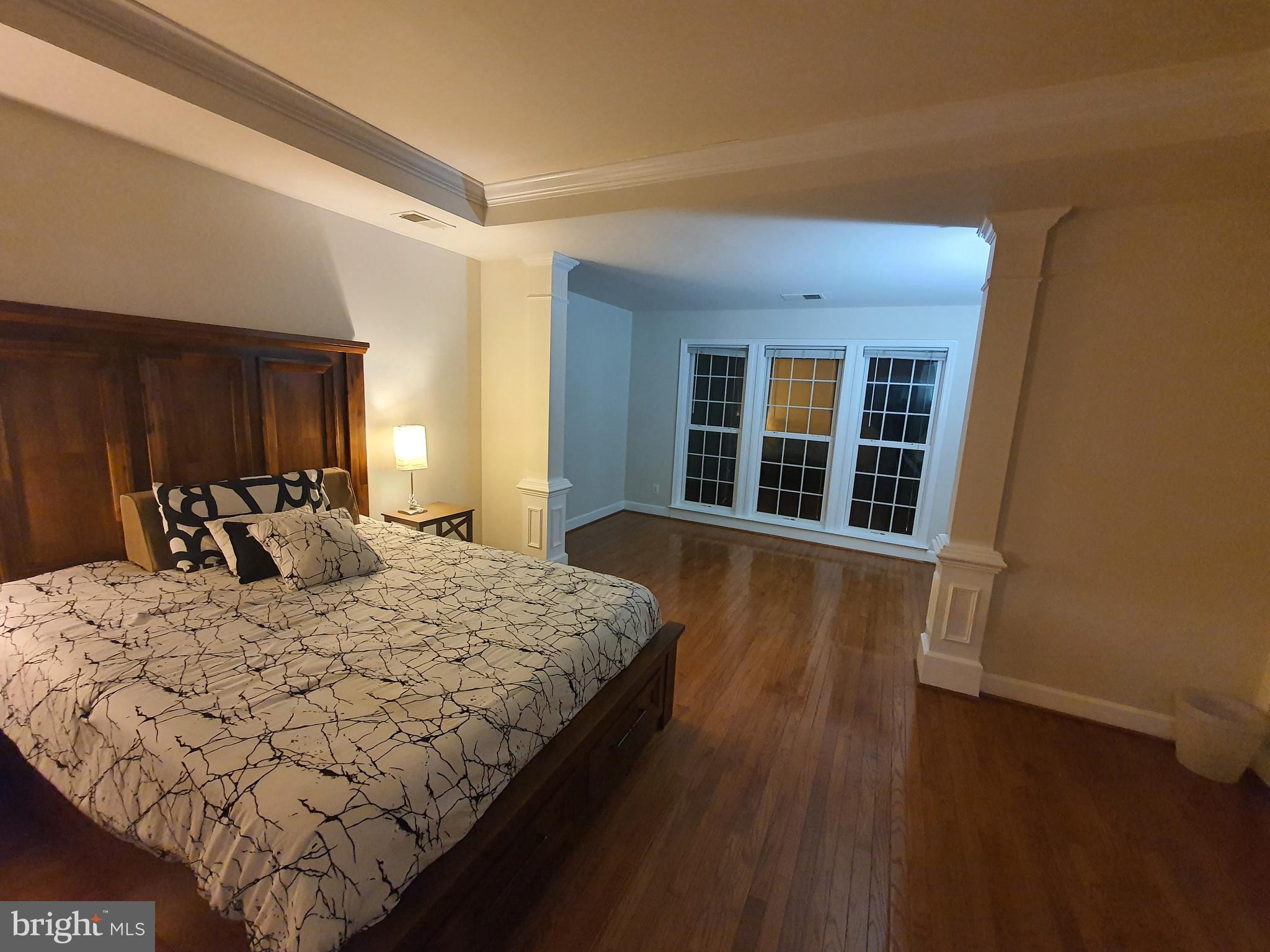 9249 Laurel Ridge Crossing Road Lorton, VA 22079 - Photo 27 of 38 a bed sitting in a bedroom next to a window