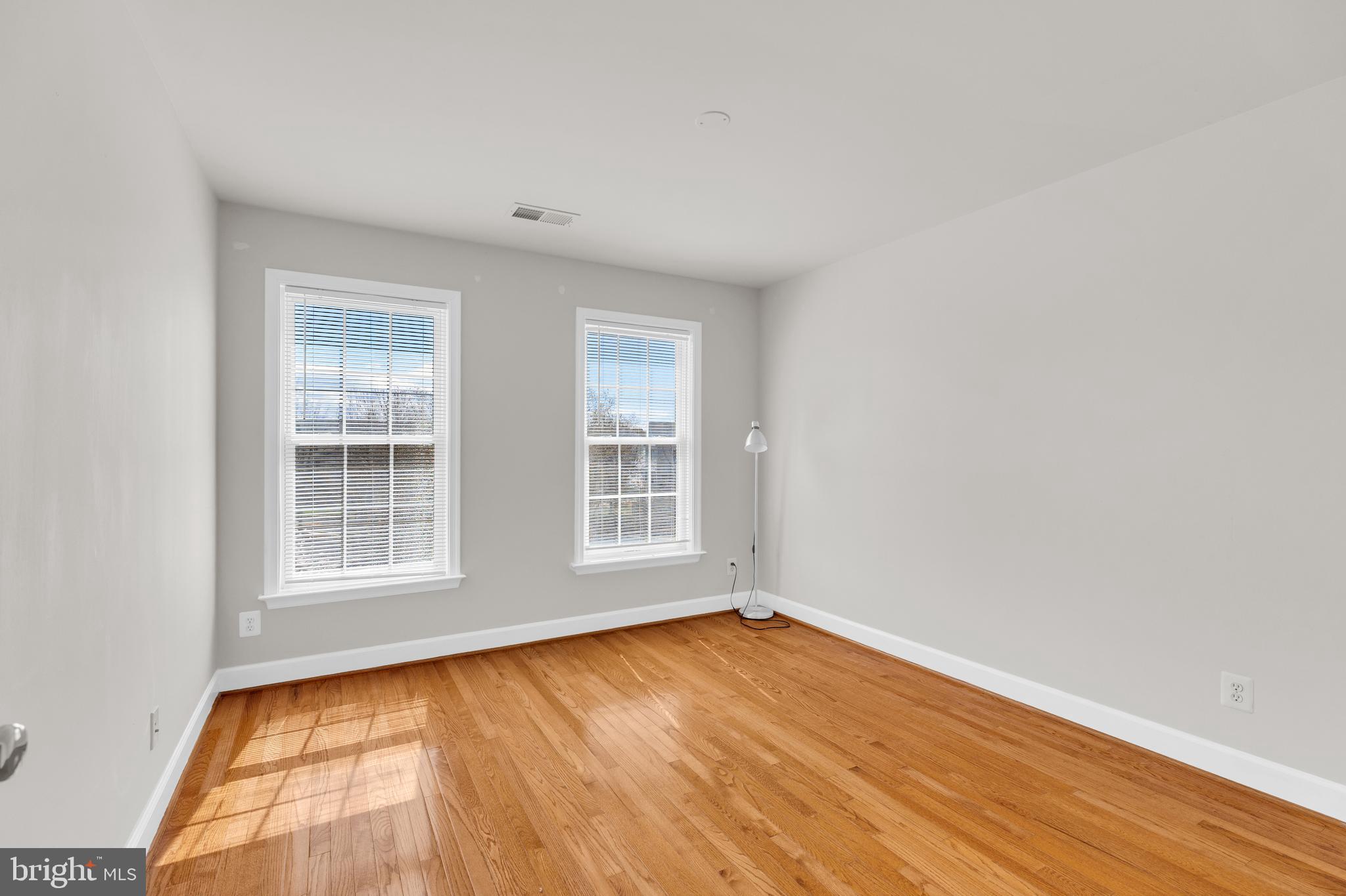 9249 Laurel Ridge Crossing Road Lorton, VA 22079 - Photo 31 of 38 an empty room with wooden floor and windows