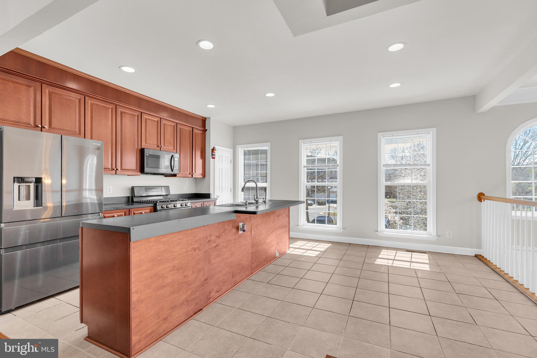 9249 Laurel Ridge Crossing Road Lorton, VA 22079 - Photo 4 of 38 a large kitchen with stainless steel appliances granite countertop a stove a refrigerator a sink and dishwasher