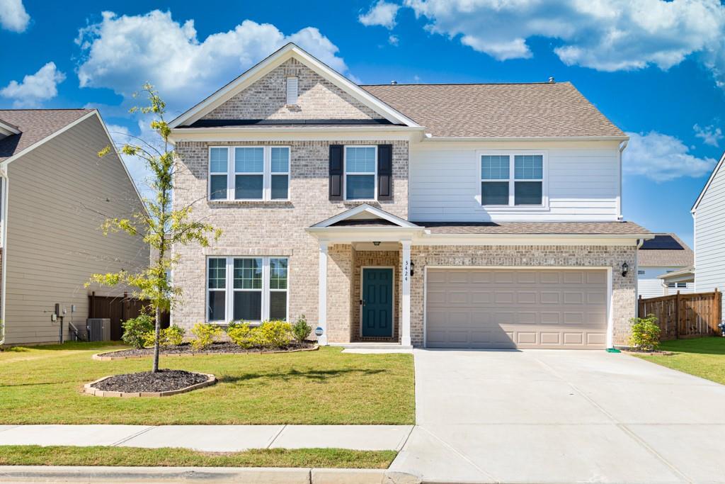 a front view of a house with a yard