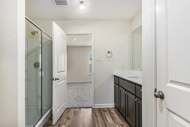a bathroom with a sink and shower