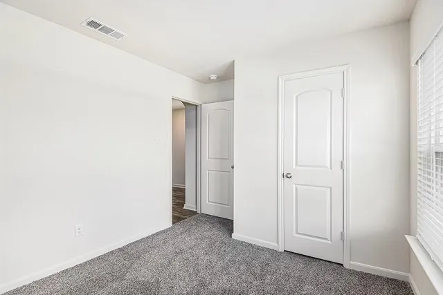 an empty room with closet area