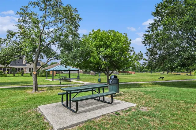 a garden with trees and wooden fence