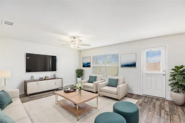 a living room with furniture and a flat screen tv