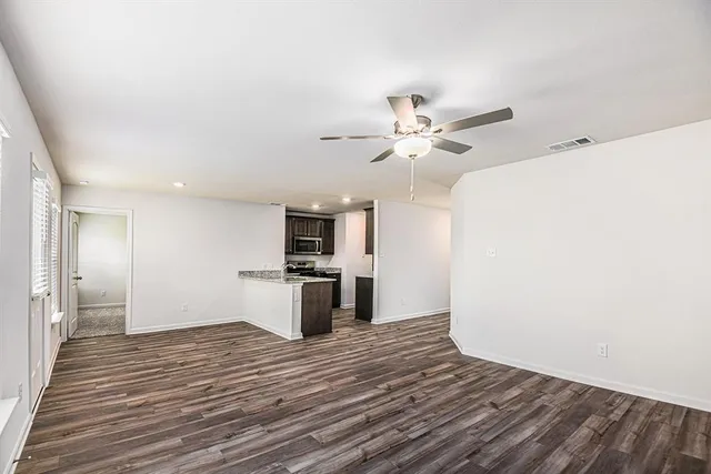 a view of a kitchen with a sink and a refrigerator