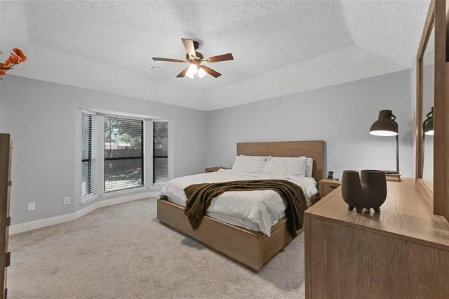 a spacious bedroom with a bed and window