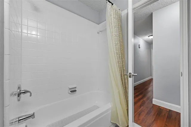 a bathroom with a bathtub and a shower