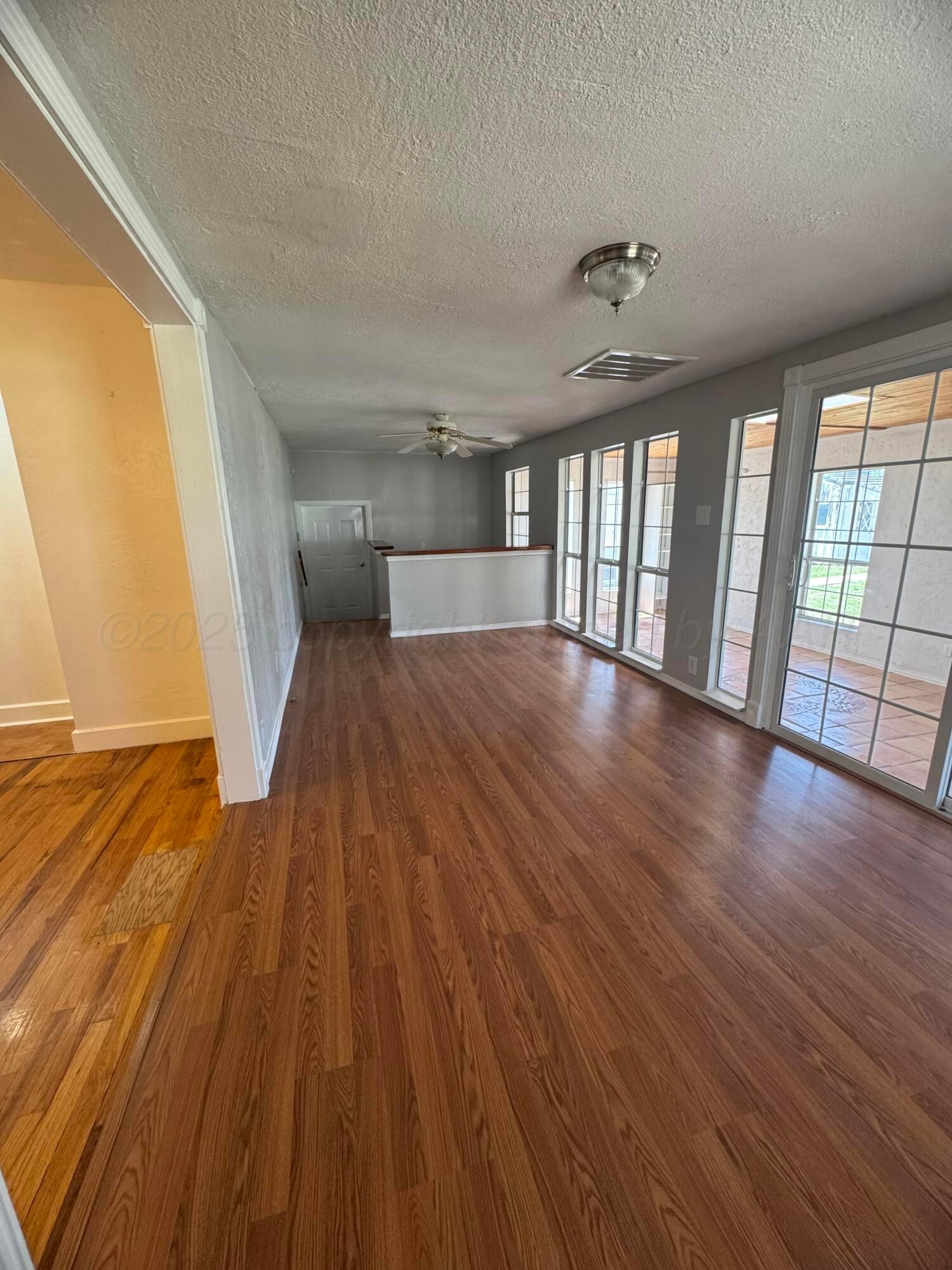 5112 Arden Road Amarillo, TX 79110 - Photo 11 of 28 wooden floor in an empty room with a window