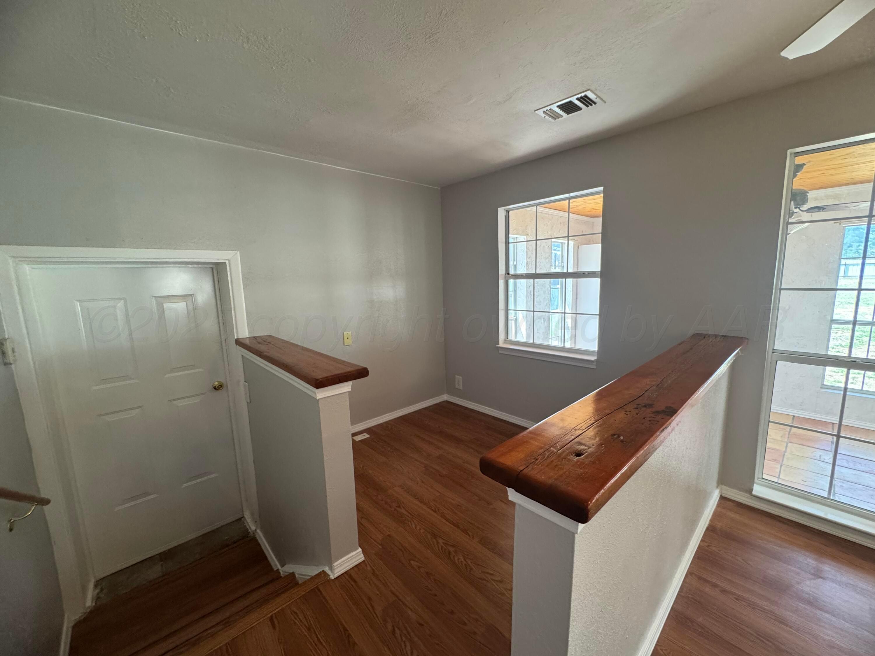 5112 Arden Road Amarillo, TX 79110 - Photo 14 of 28 a room with window and wooden floor