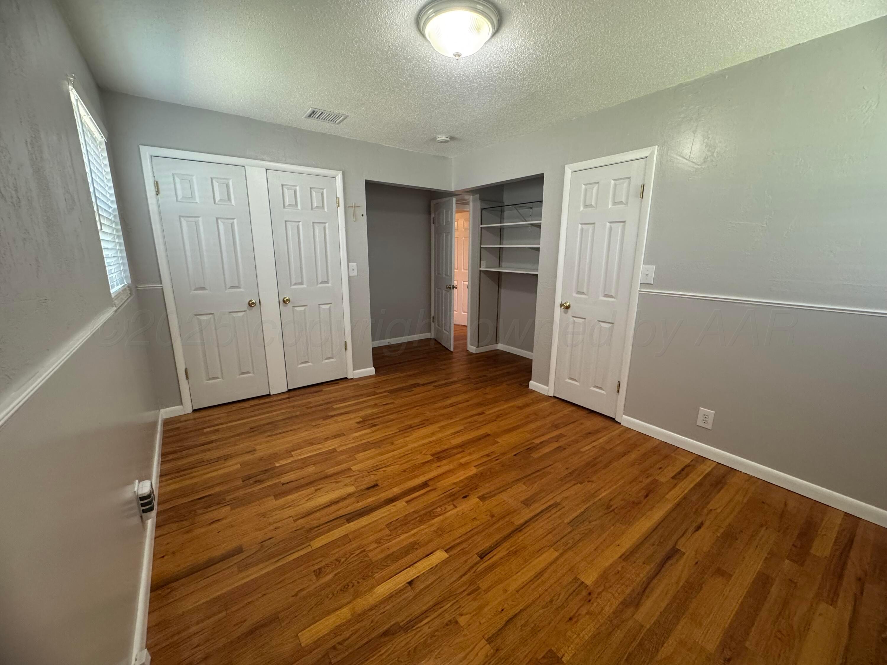 5112 Arden Road Amarillo, TX 79110 - Photo 15 of 28 a view of empty room with wooden floor